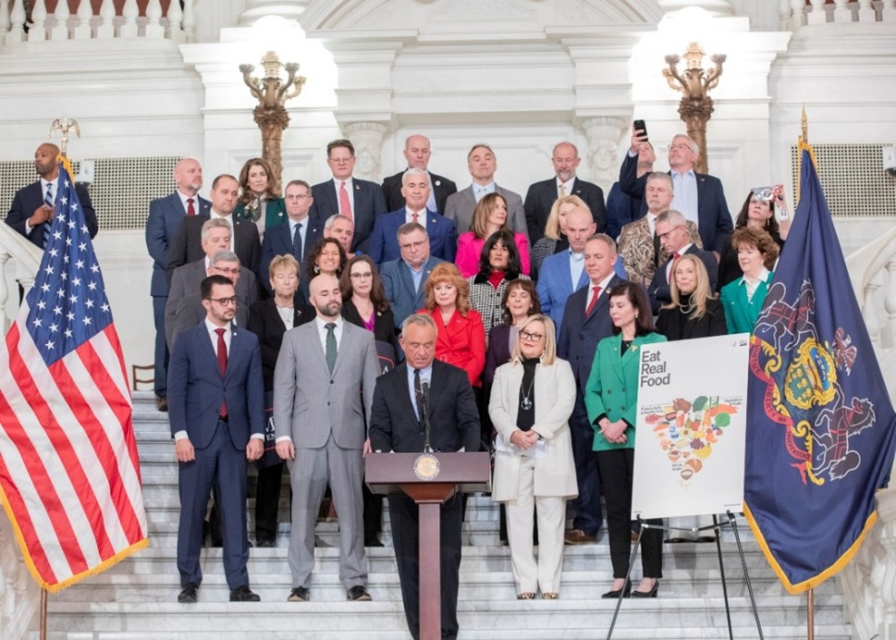 Rep. Jamie Flick joins fellow lawmakers as Secretary Kennedy speaks at the “Eat Real Food” kickoff. 